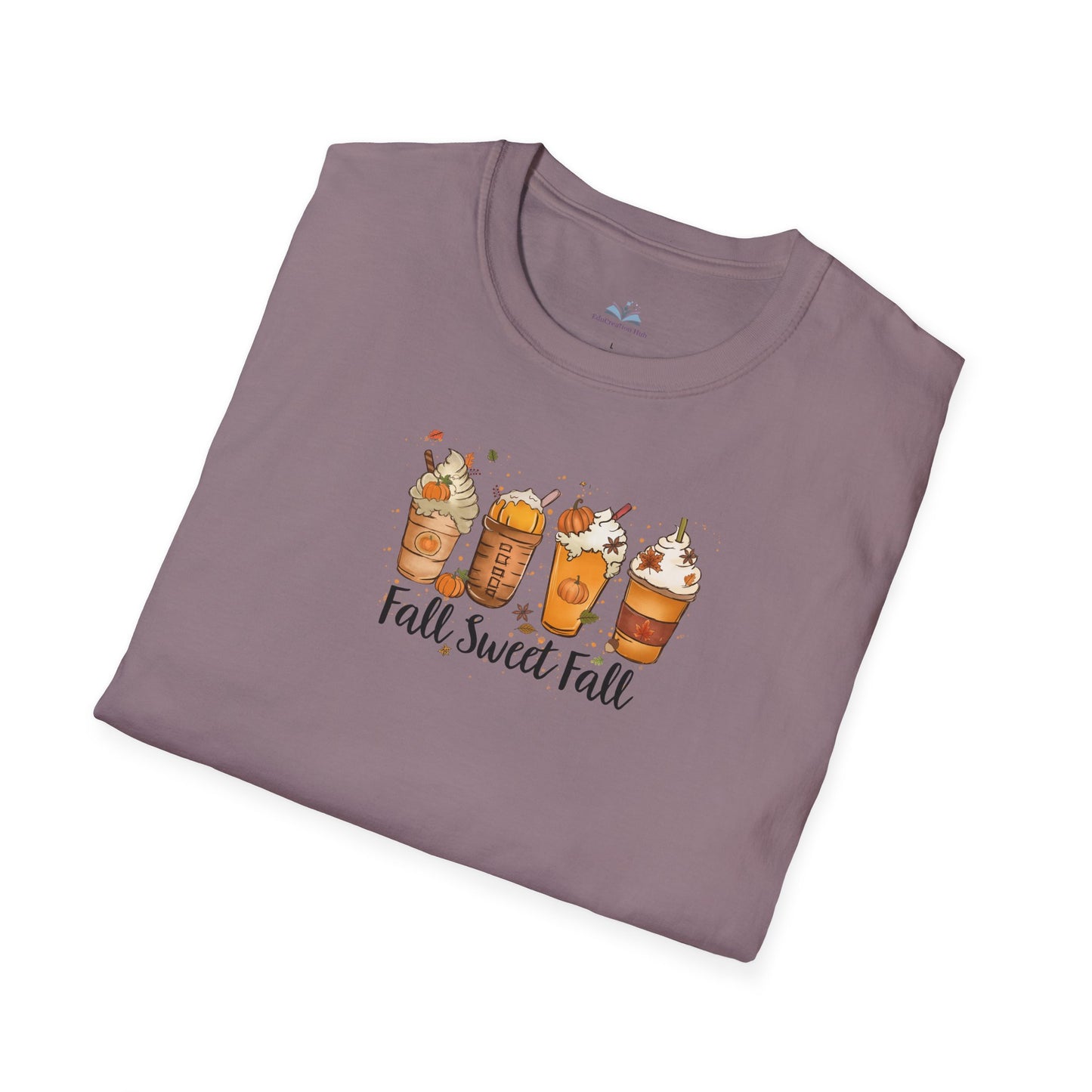 Folded purple t-shirt with fall-themed design on a white background