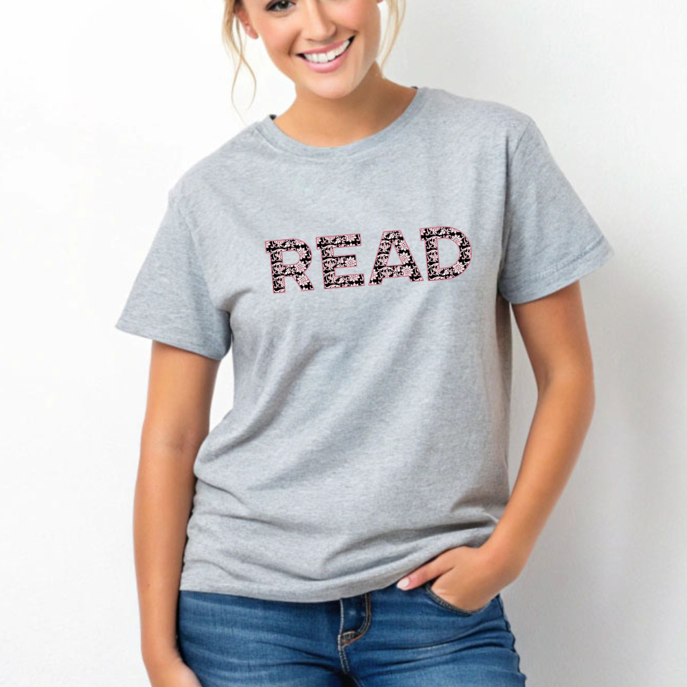 Person wearing a gray t-shirt with 'READ' printed on it against a white background