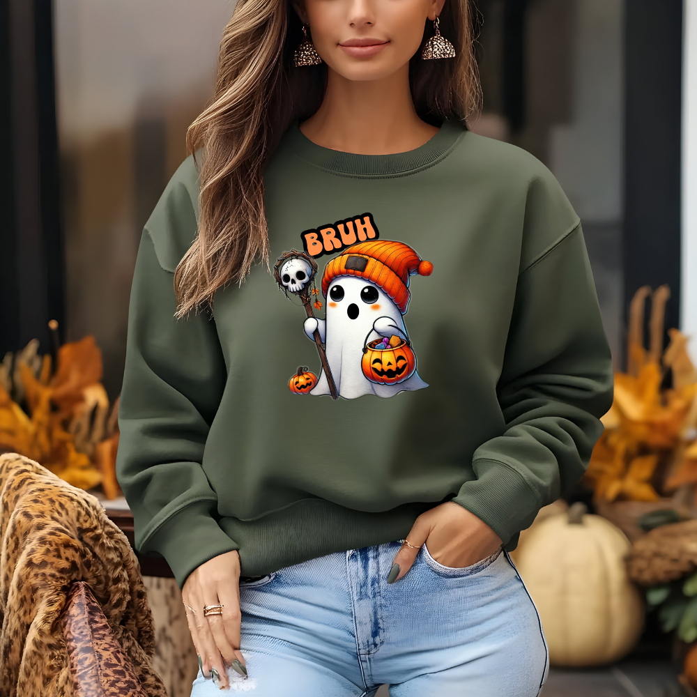 Person wearing a green sweatshirt with Halloween-themed design in an outdoor setting with pumpkins.