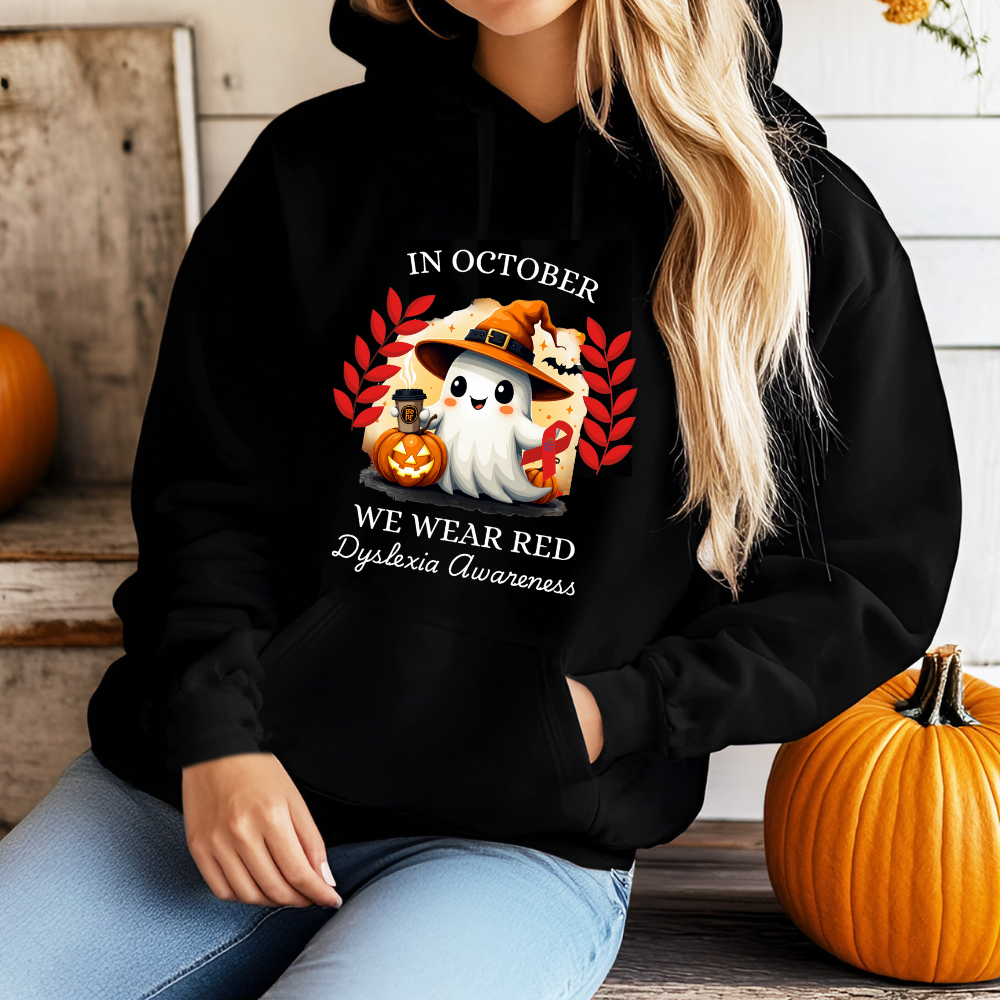 Person wearing a black hoodie with Halloween-themed design and text about Dyslexia Awareness.