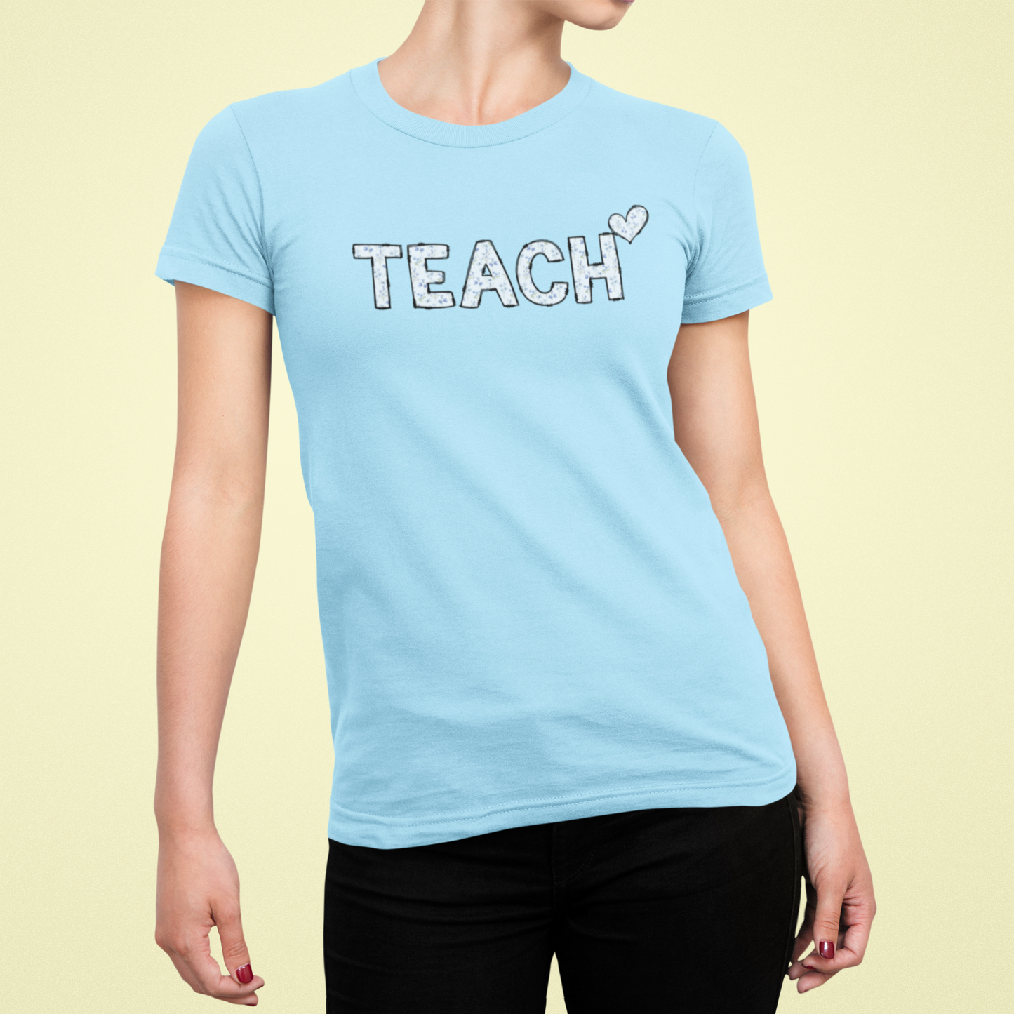Light blue t-shirt with 'TEACH' text on a yellow background