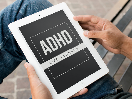 Person holding a tablet with 'ADHD Life Planner' on the screen
