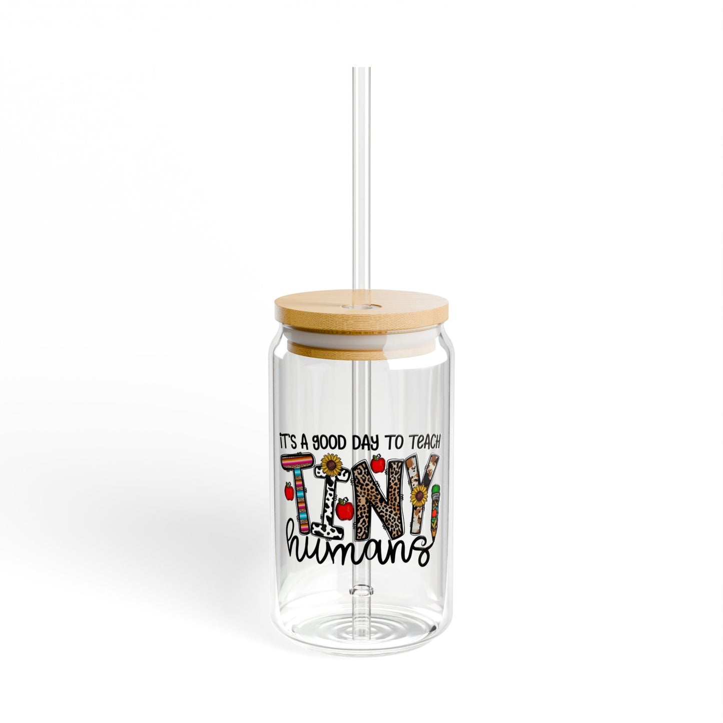 Clear tumbler with colorful text and wooden lid on a white background