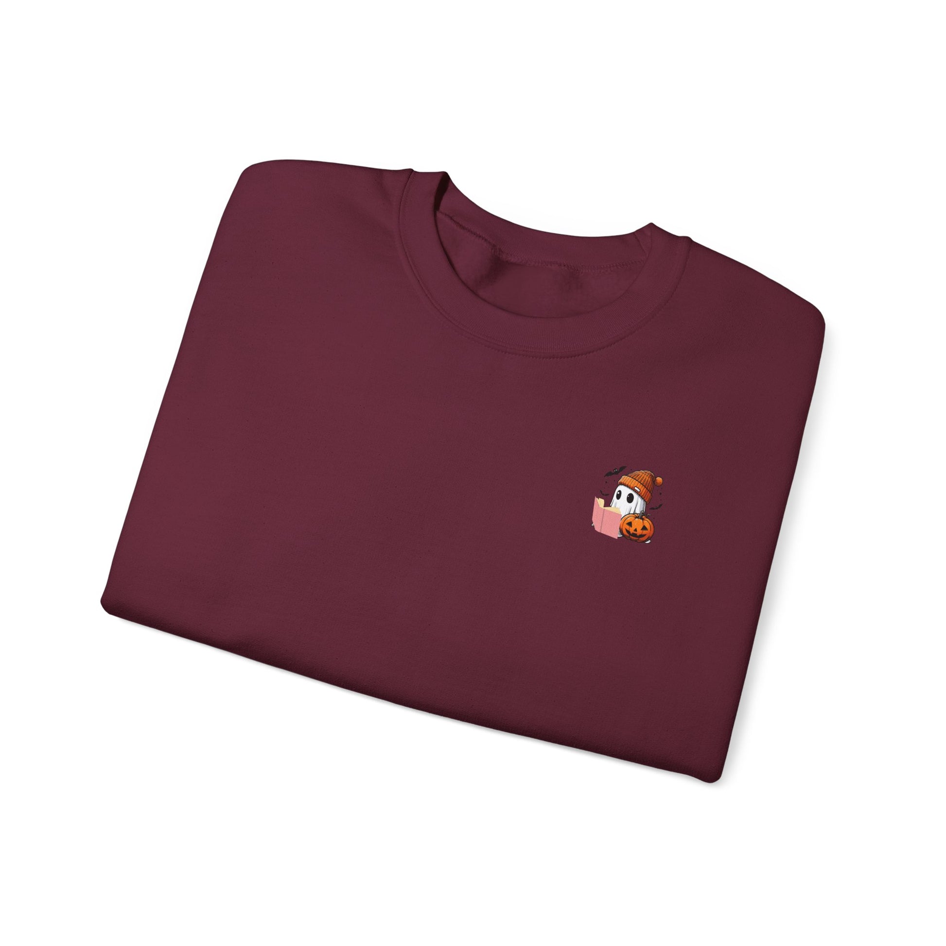 Folded maroon sweatshirt with a small embroidered design on a white background