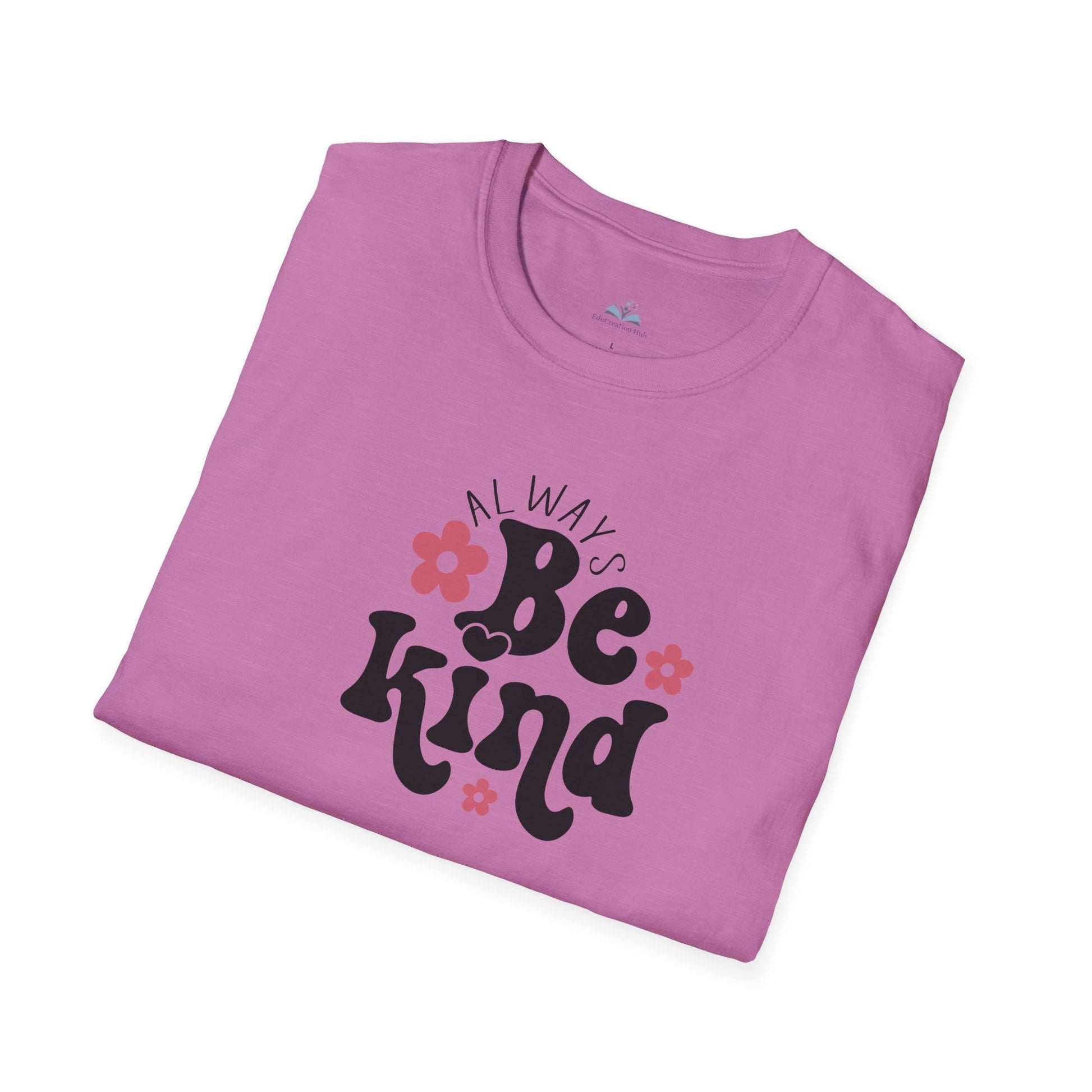 Folded pink t-shirt with 'Always Be Kind' text on a white background