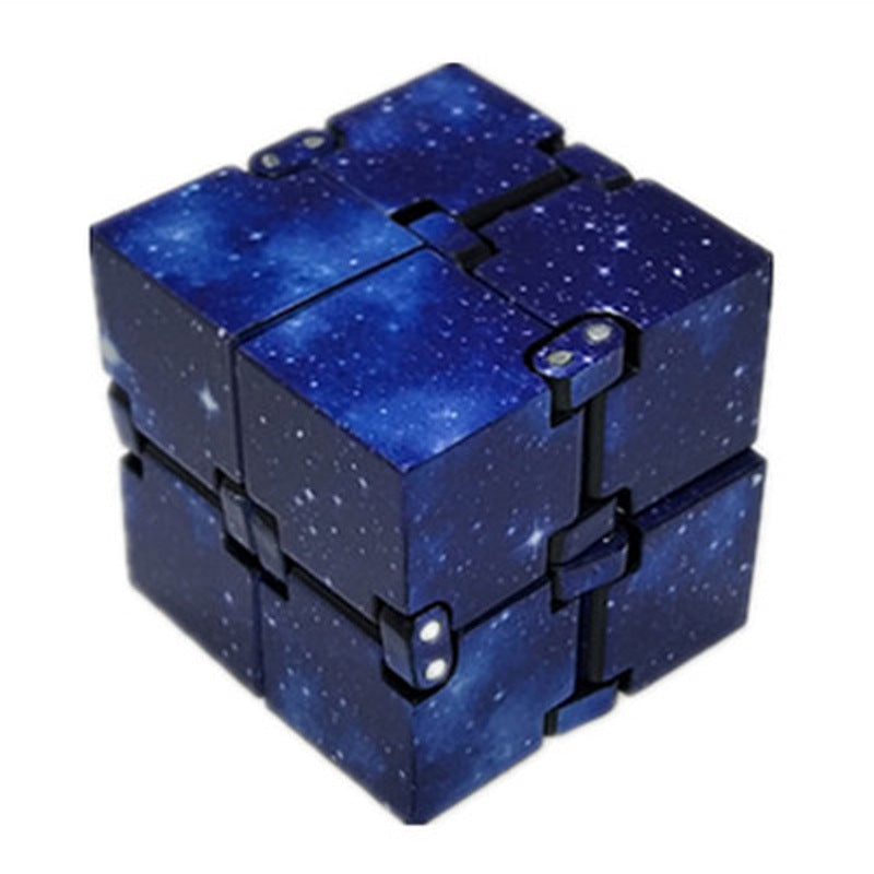 Blue starry sky patterned fidget cube on a white background