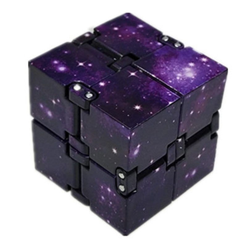 Purple galaxy-themed fidget cube on a white background