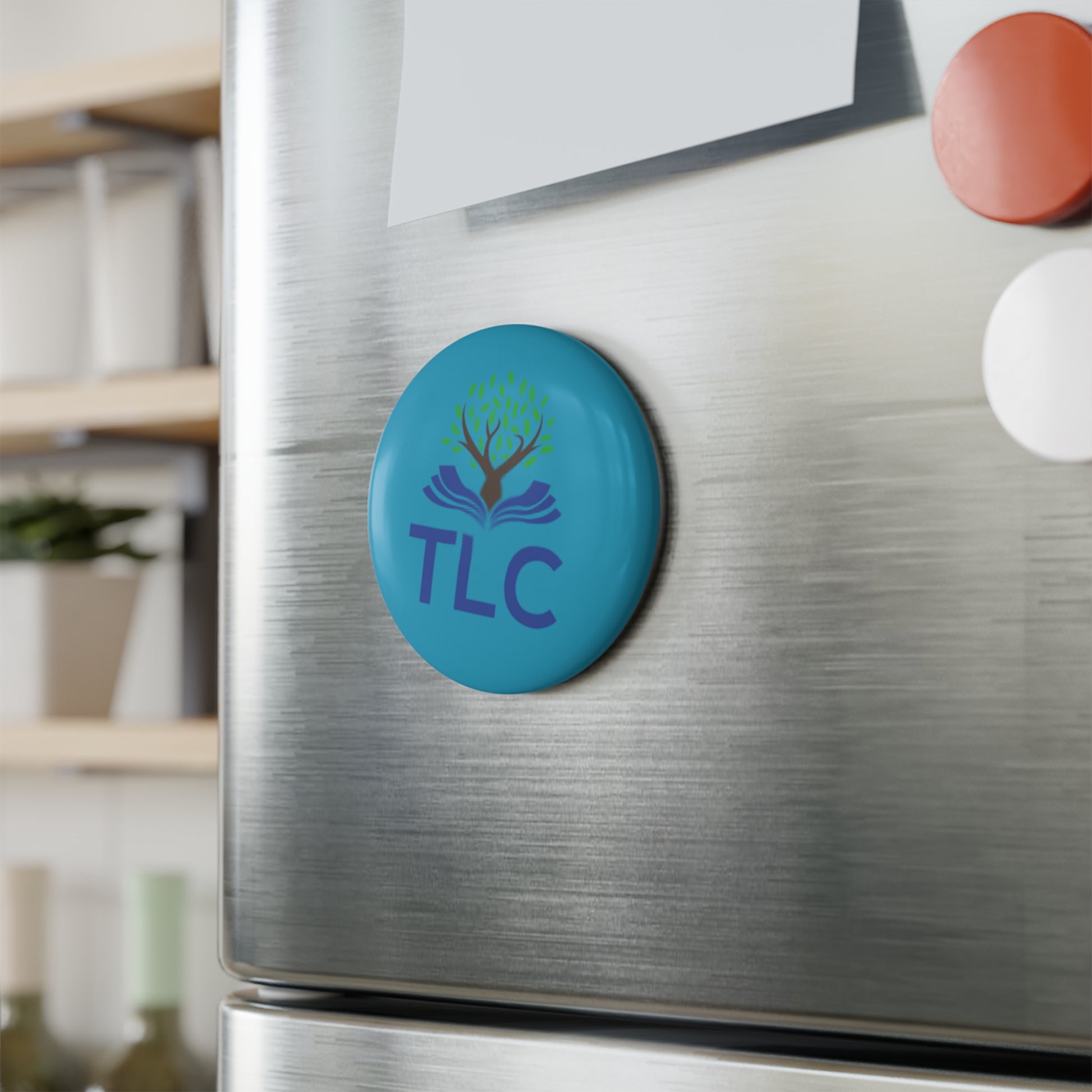Blue magnet with 'TLC' logo on a refrigerator