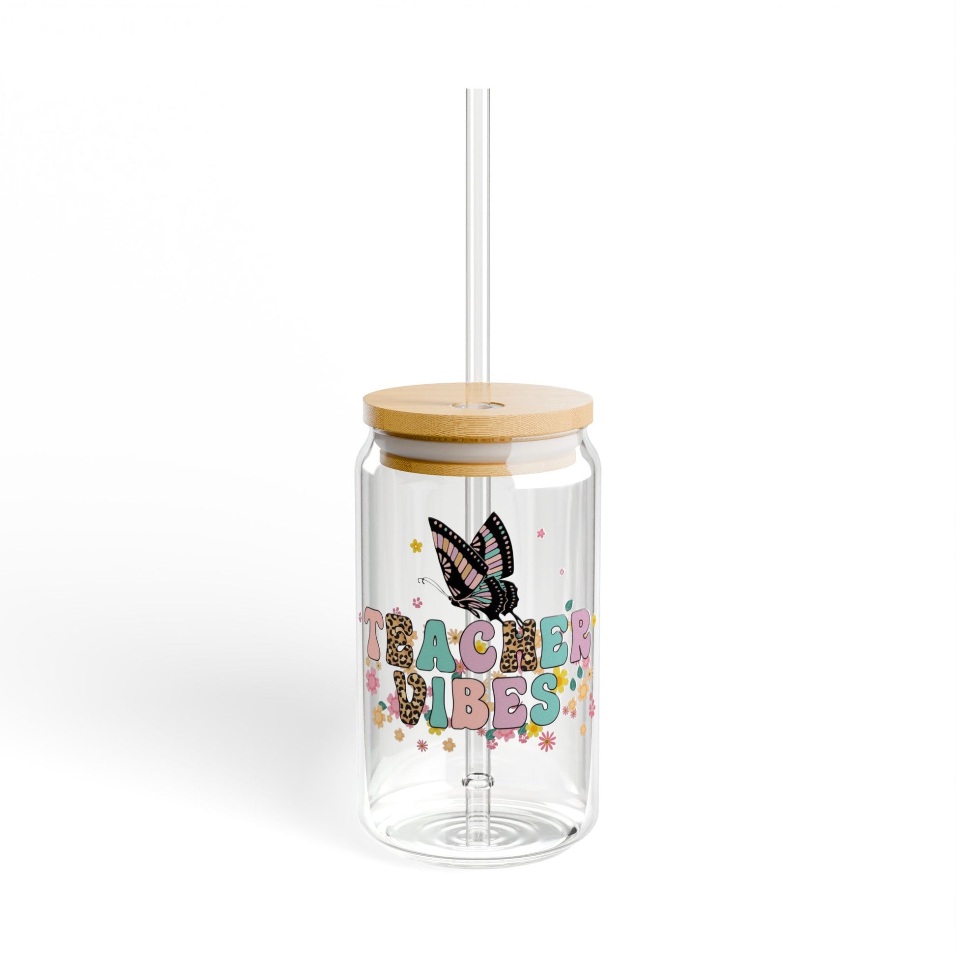 Clear tumbler with wooden lid and straw, featuring a butterfly and 'Teacher Vibes' text on a white background.