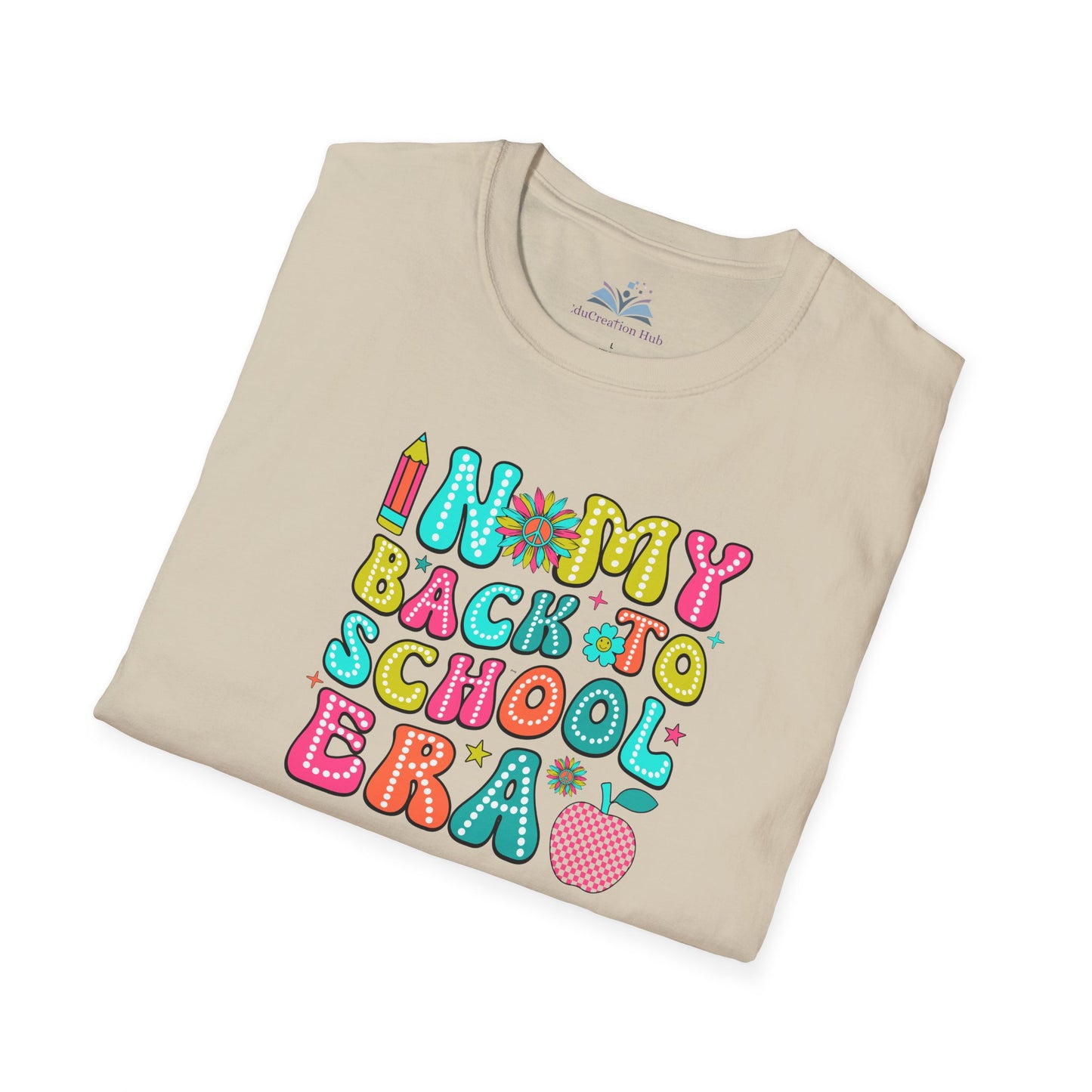 Folded beige t-shirt with colorful 'Back to School' text design on a white background