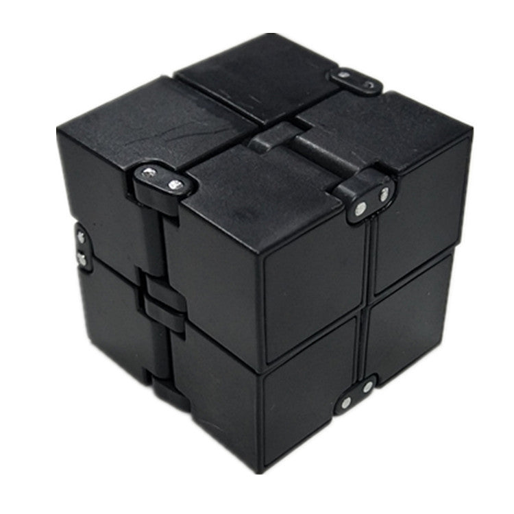 Black fidget cube on a white background