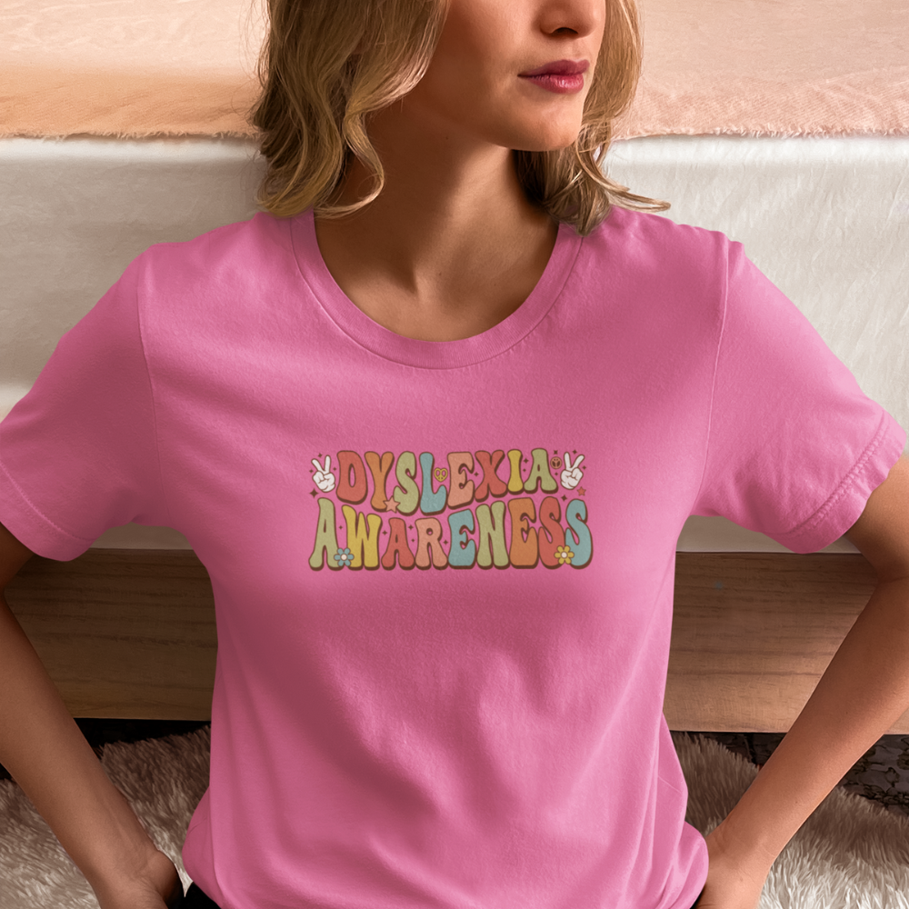 Person wearing a pink t-shirt with 'Dyslexia Awareness' text.