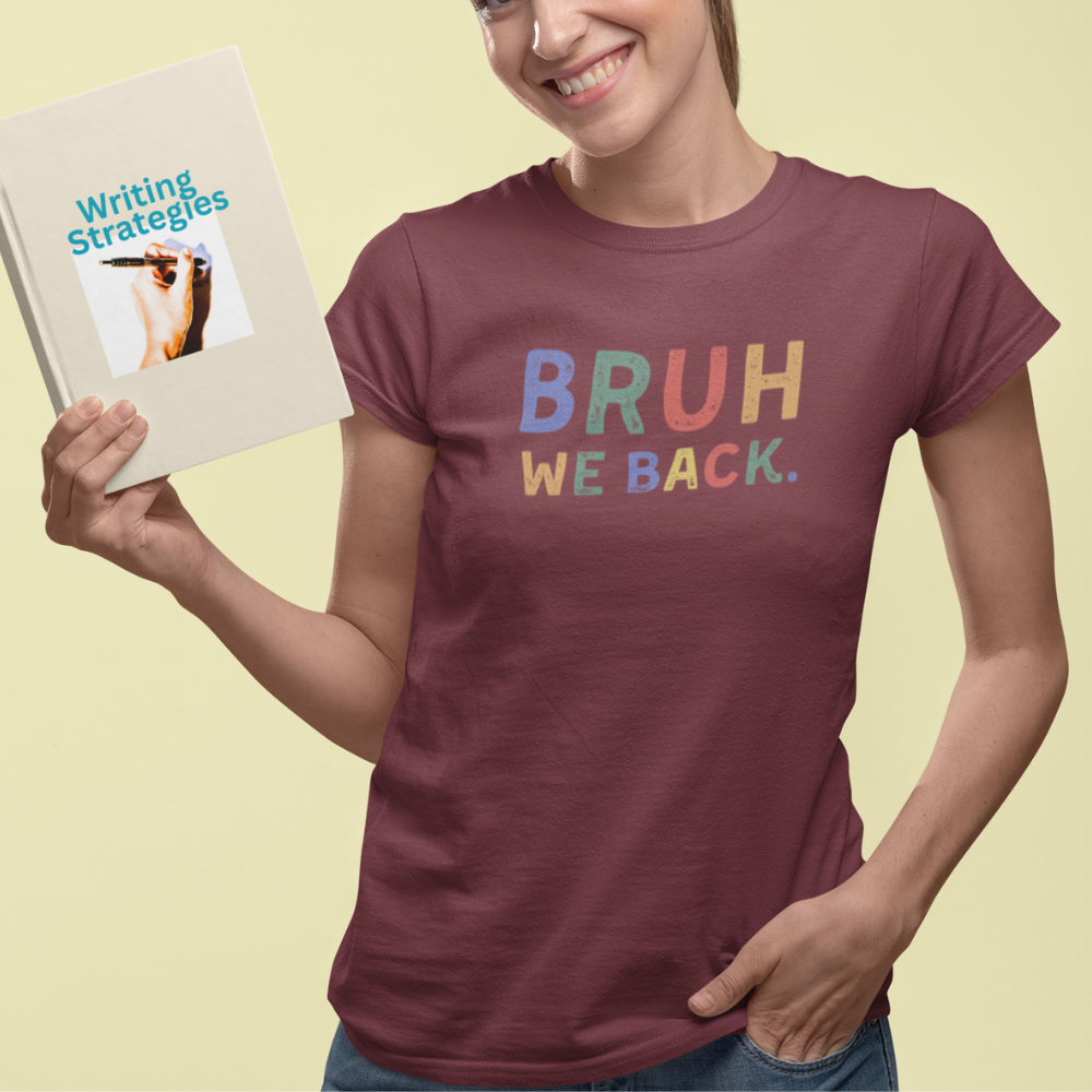 Person wearing a maroon t-shirt with 'BRUH WE BACK.' text, holding a book titled 'Writing Strategies'.
