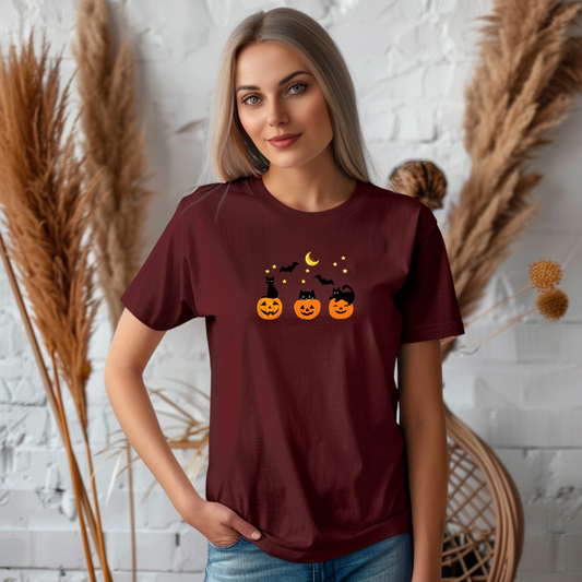 Woman wearing a maroon t-shirt with Halloween-themed design against a decorative background