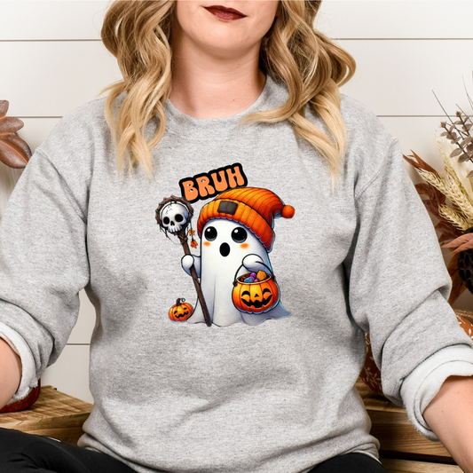 Person wearing a gray sweatshirt with a Halloween-themed design featuring a ghost, skeleton, and pumpkin.