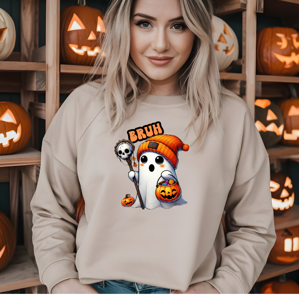 Woman wearing a beige sweatshirt with Halloween-themed design in front of shelves with carved pumpkins.