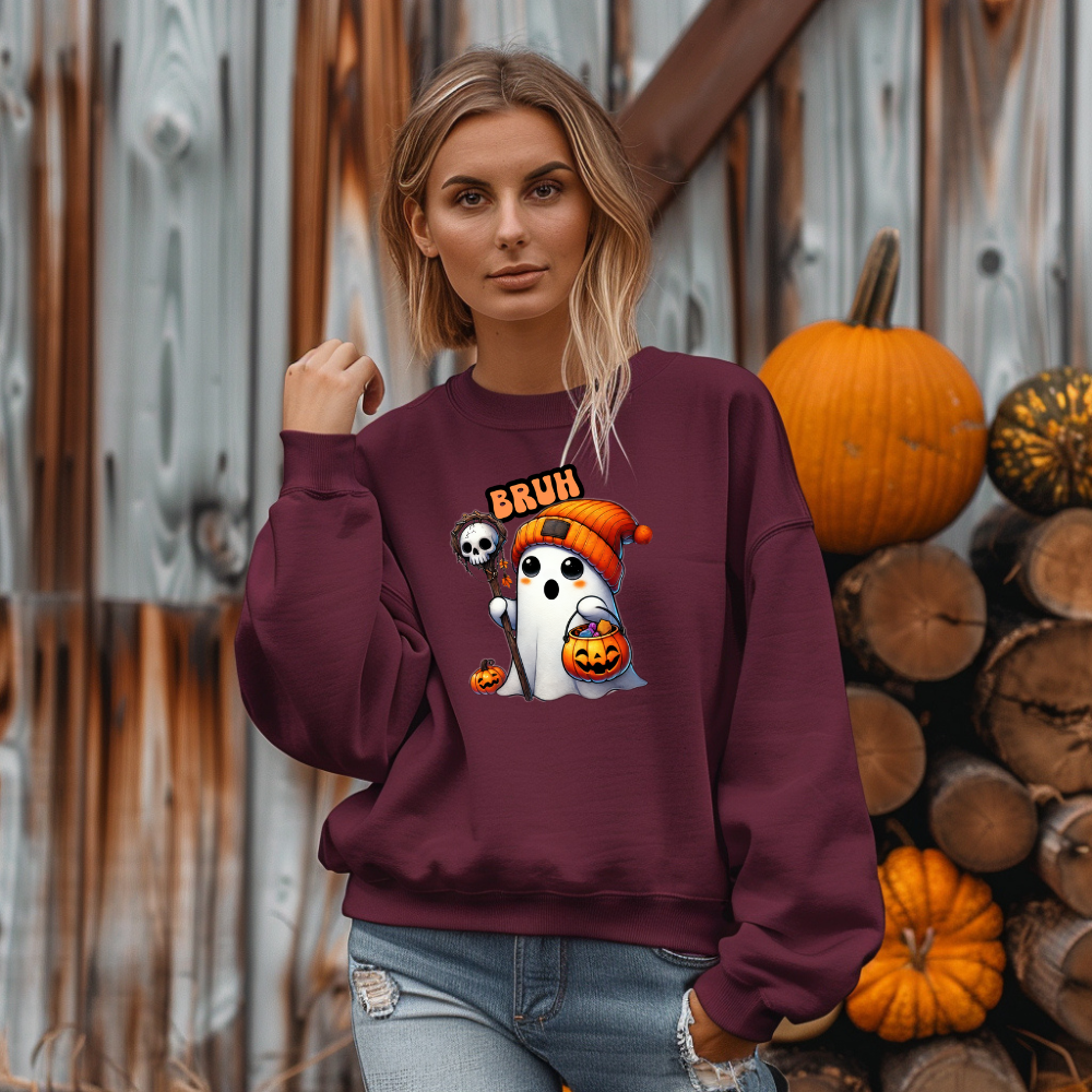 Woman wearing a maroon sweatshirt with Halloween-themed design in front of pumpkins and wooden logs.