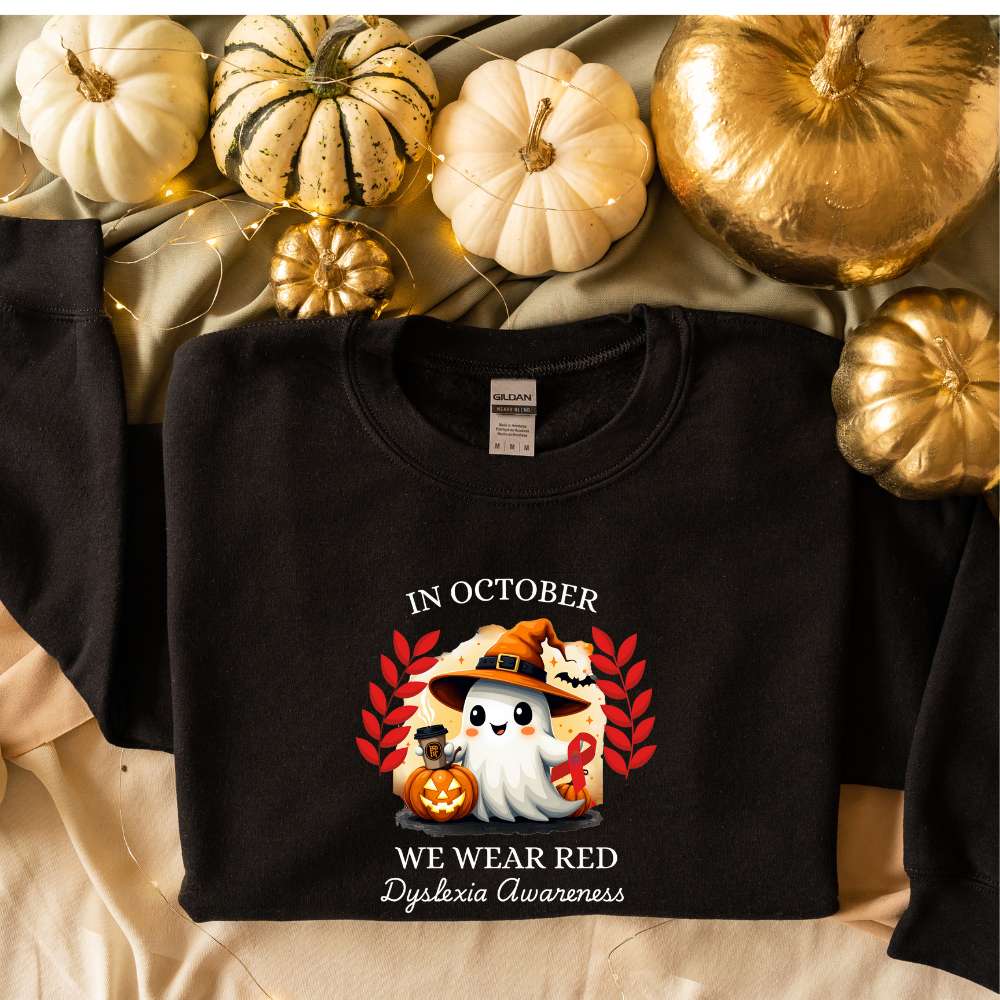 Black shirt with Halloween design and text, surrounded by pumpkins.