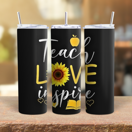 Three black tumblers with motivational text and graphics on a wooden surface.