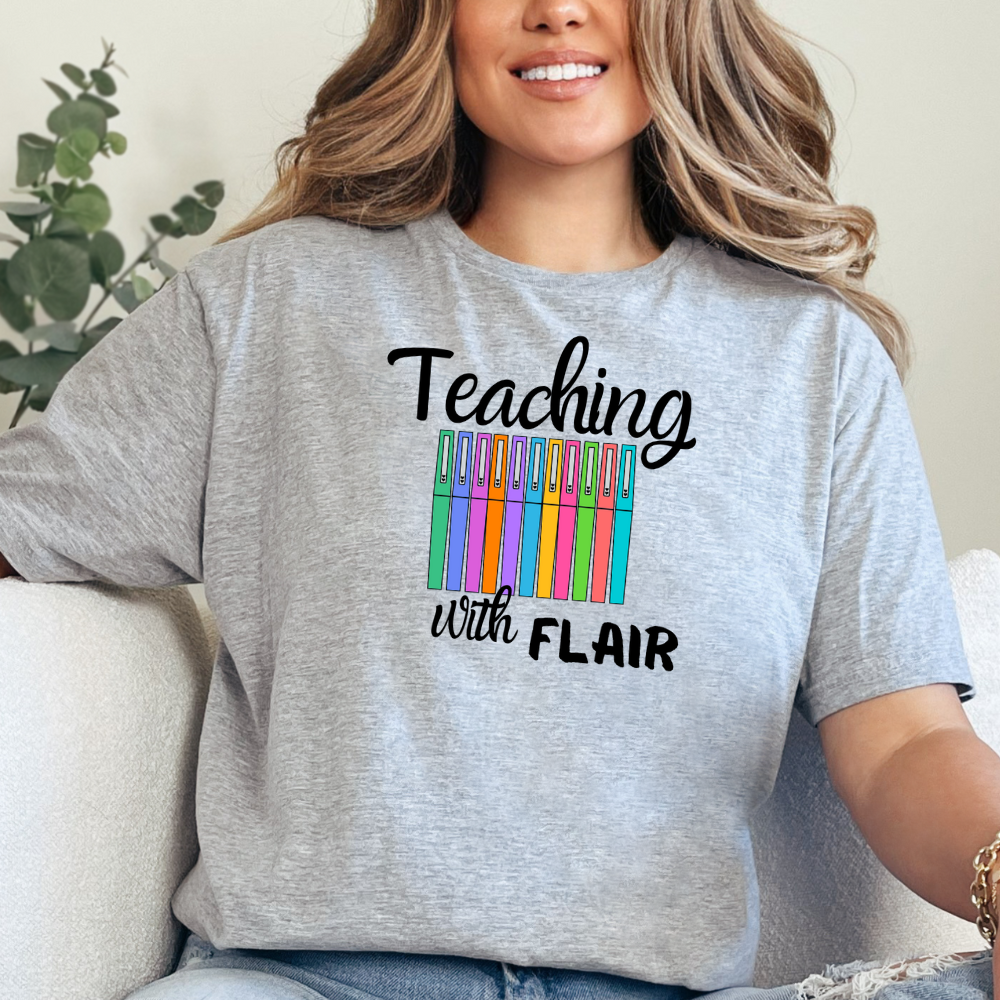 Person wearing a gray t-shirt with 'Teaching with Flair' text and colorful design.