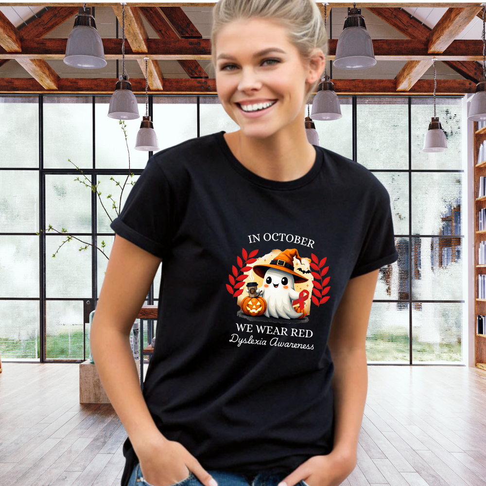 Woman wearing a black t-shirt with a graphic design and text in a room with large windows.