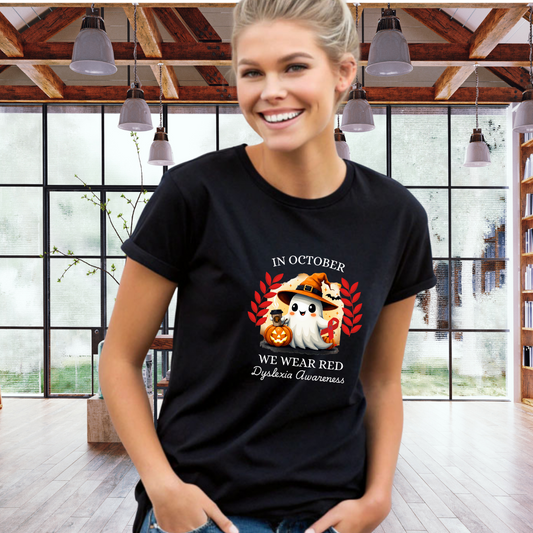 Woman wearing a black t-shirt with a graphic design and text in a room with large windows.