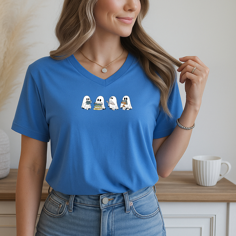 Person wearing a blue t-shirt with cartoon ghosts on a neutral background