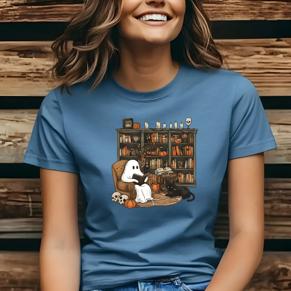 Person wearing a blue t-shirt with a Halloween-themed graphic against a wooden background