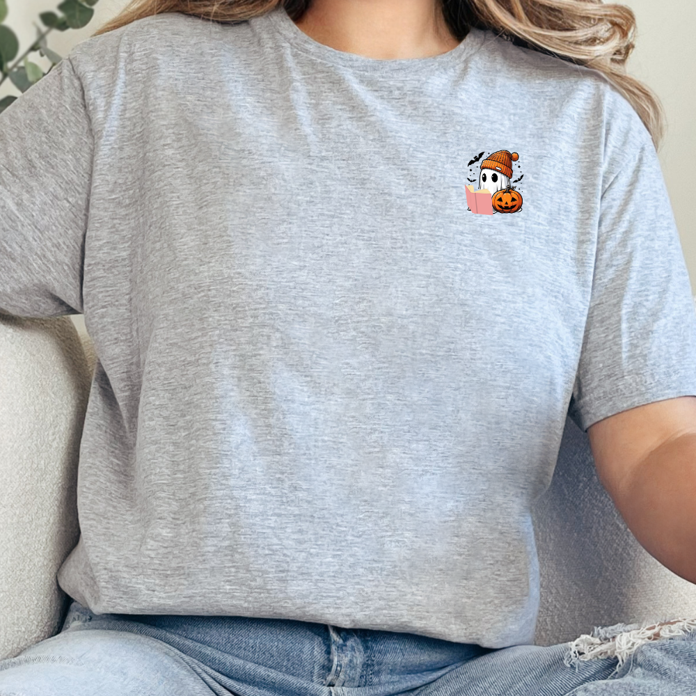 Person wearing a gray t-shirt with a cartoon character design on a beige couch.