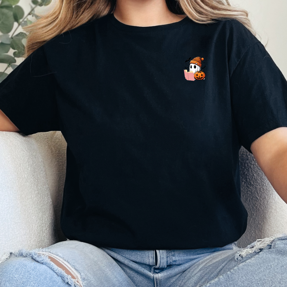 Person wearing a black t-shirt with a small graphic design sitting on a couch.
