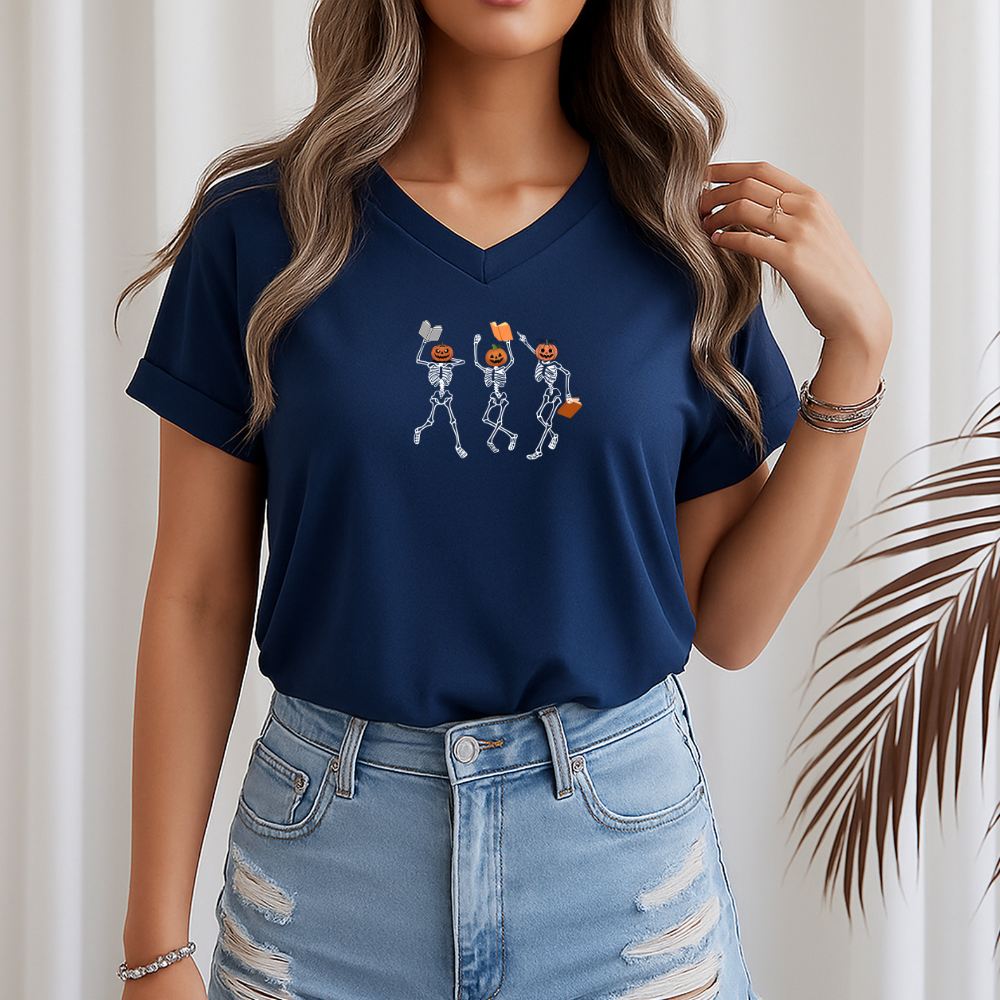 Person wearing a navy blue t-shirt with skeleton design and light blue jeans against a neutral background