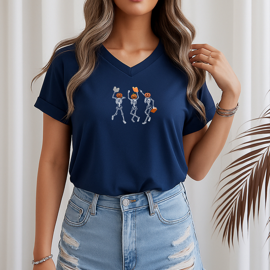 Person wearing a navy blue t-shirt with skeleton design and light blue jeans against a neutral background