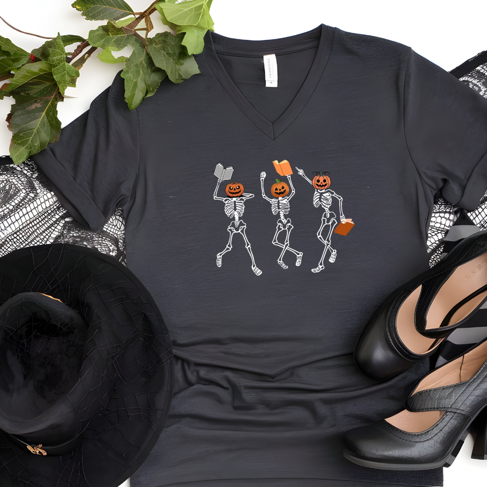 Black t-shirt with skeleton design surrounded by decorative items on a white background