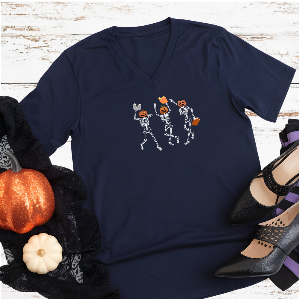 Navy blue t-shirt with skeleton design on a wooden surface with pumpkins and shoes.