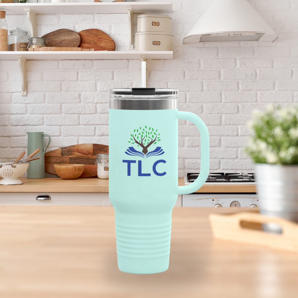 Mint green travel mug with TLC logo on a kitchen counter